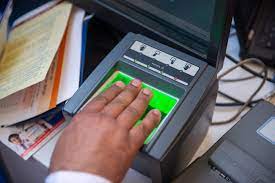 Hand placing fingers on fingerprint scanner device for contractor license application biometric capture